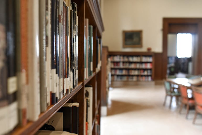 Books on a library shelf.