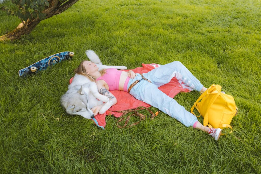 woman chilling in the park with her dog 