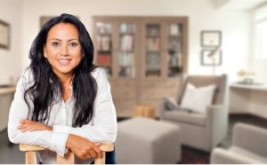 Woman smiling in a cozy home.