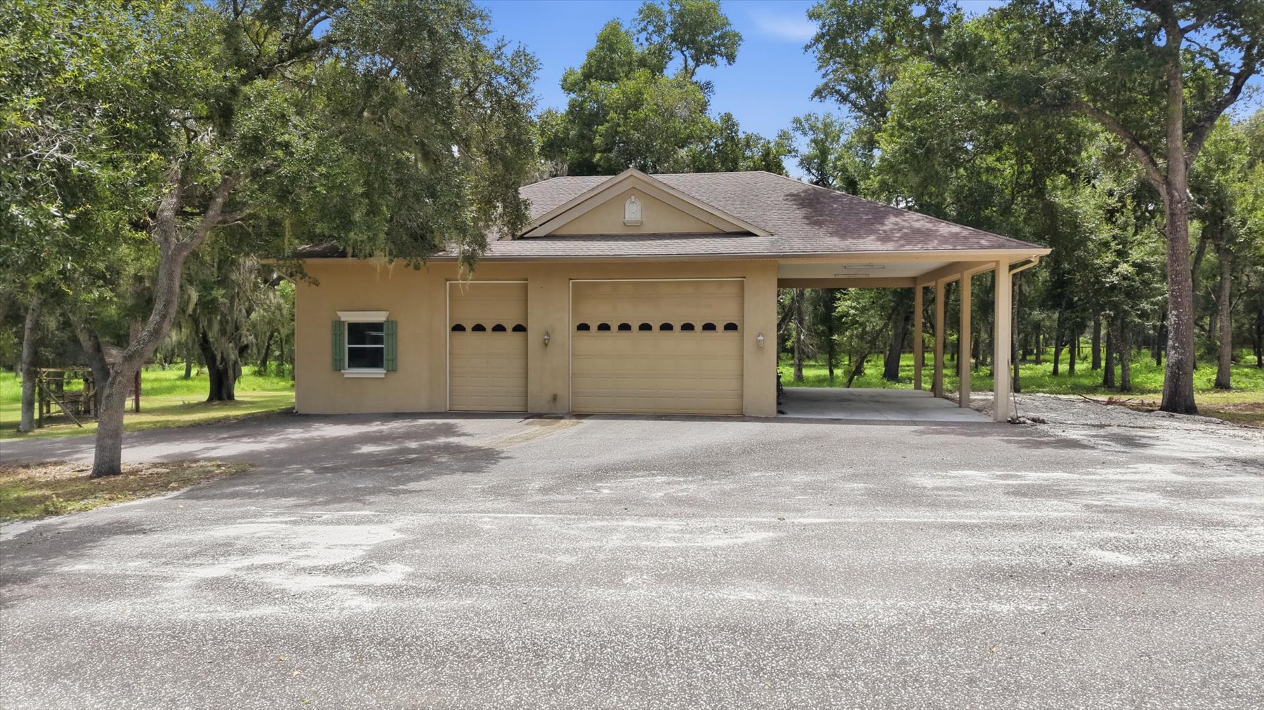 Detached garage with multiple bays and covered storage